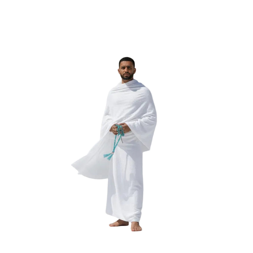 Man in white Ihram clothes holding a string on a plain background