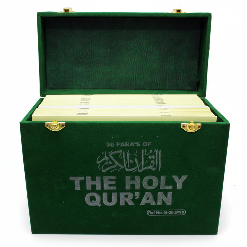 Green box containing the Holy Quran with gold accents on a white background
