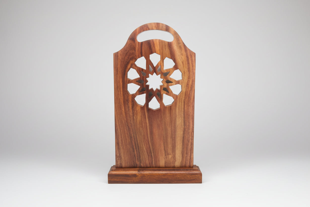 Handmade wooden Sutrah stand with geometric cut-outs, designed for use in mosques or homes for holding prayer mats.
