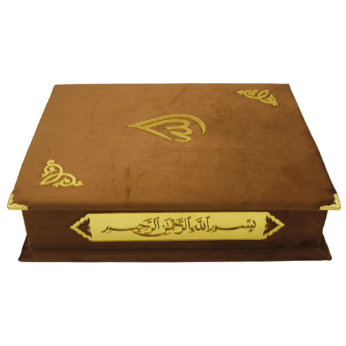 A brown book with a golden velvet cover featuring Arabic calligraphy, presumably containing the Holy Quran.